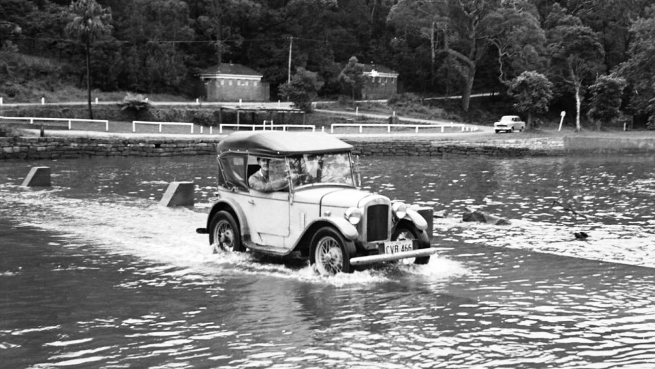 Classic car driving on flooded Audley Weir